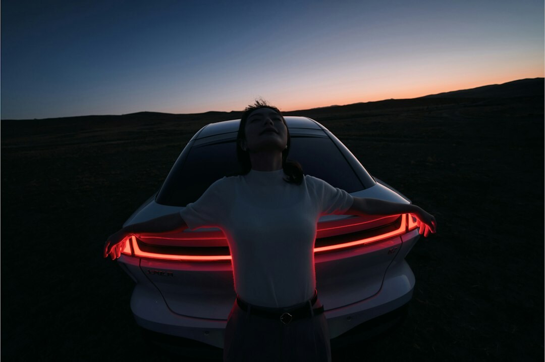 Electric performance hypercar with illuminated light strip at night