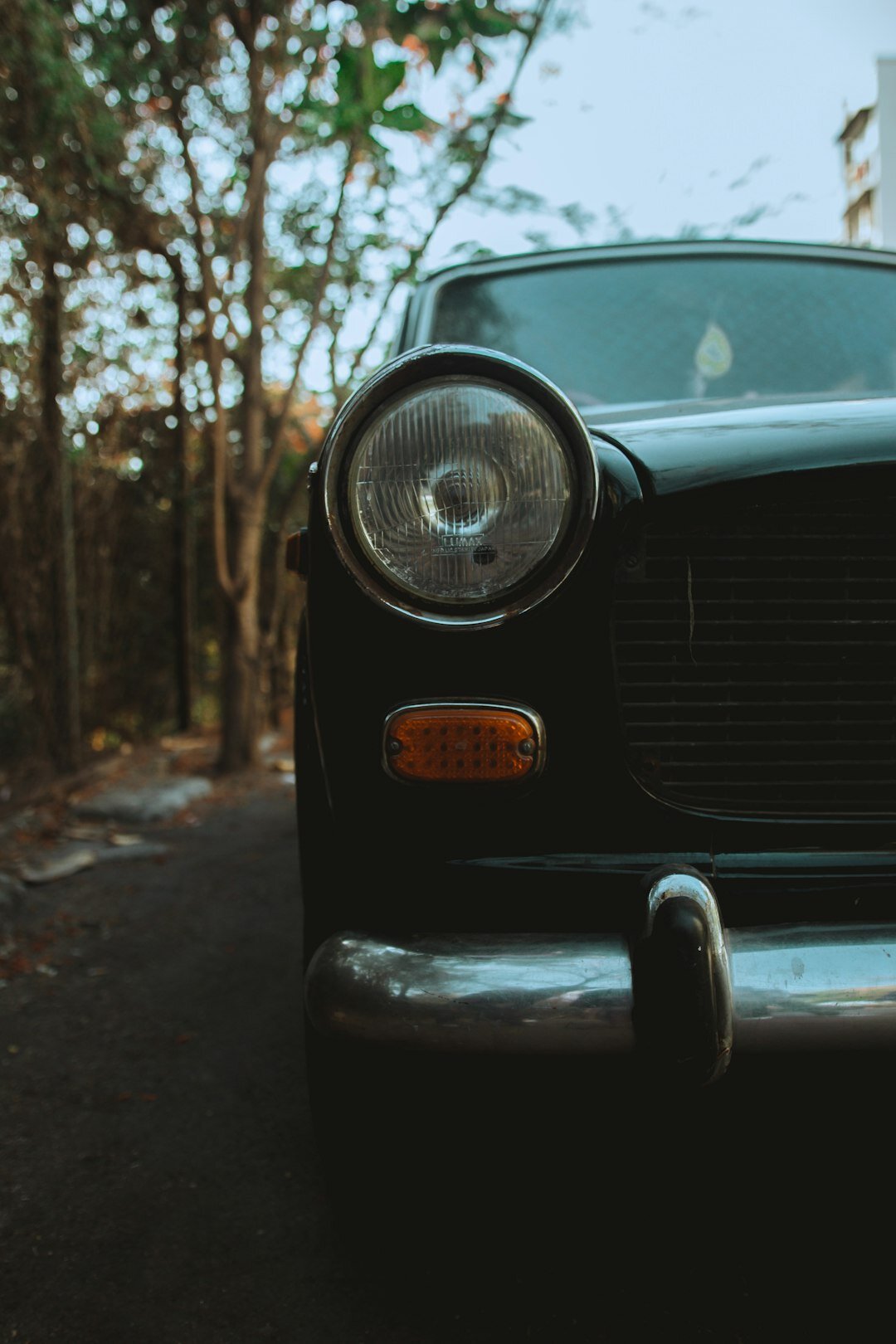 Classic 1960s coupe with a two-tone paint finish parked on an empty road