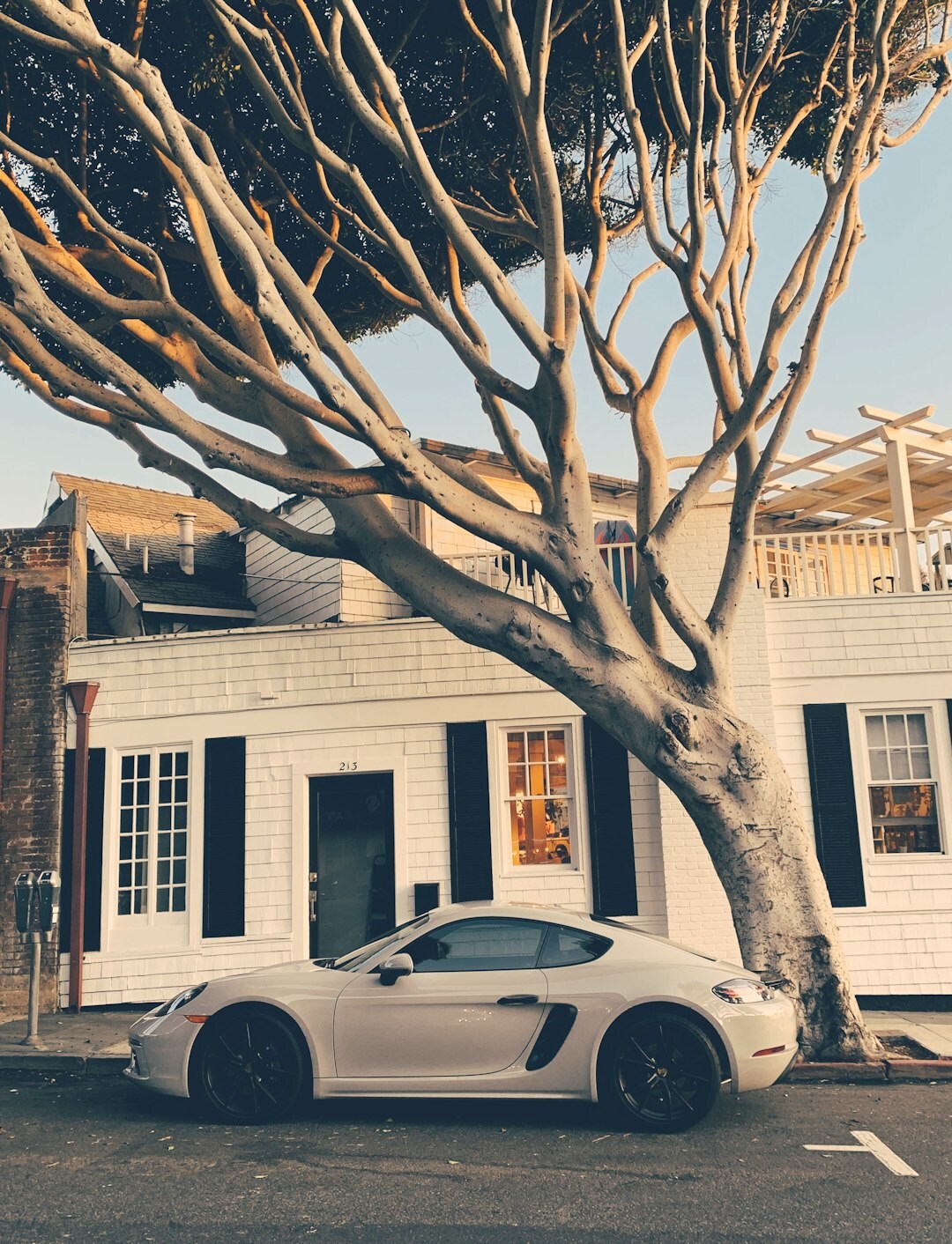 Exotic vintage automobile parked in front of a modern beach house in Punta del Este