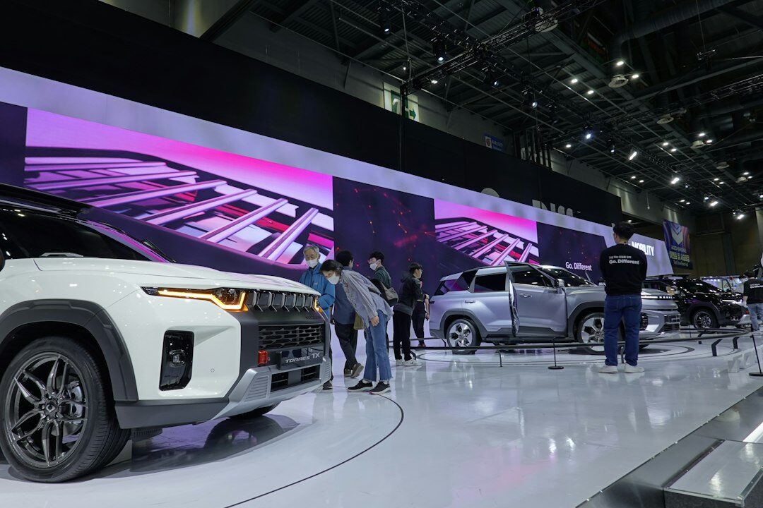 Interior view of a virtual automobile gallery with illuminated display pods