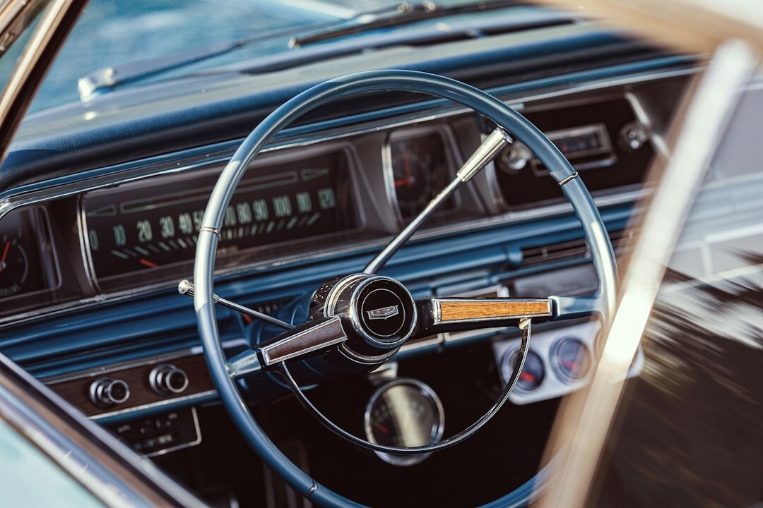Close-up detail of a classic automobile dashboard and steering wheel