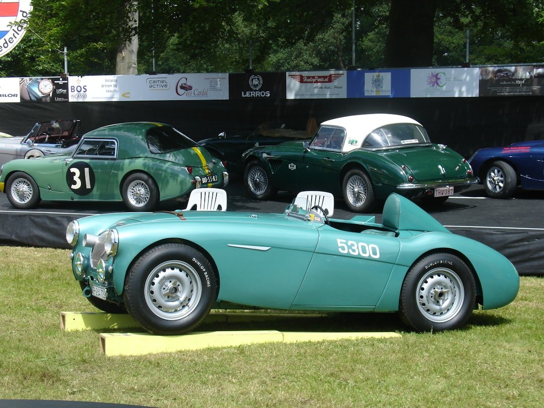 British racing green vintage roadster displayed at a classic car auction