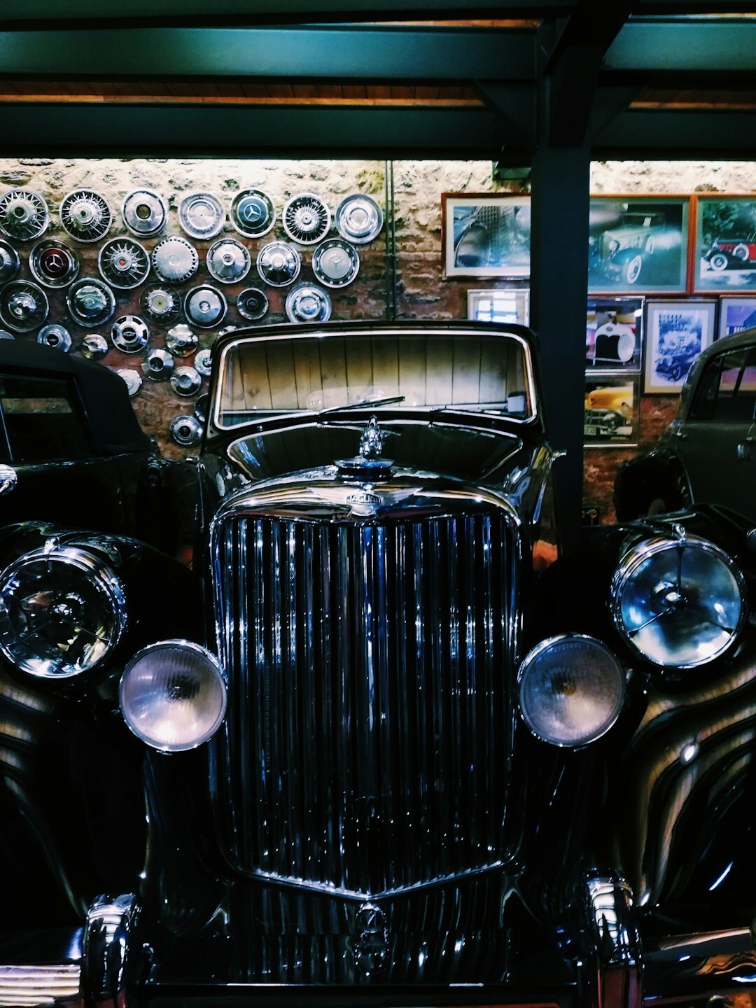 Interior of a classic car museum with spotlighted vintage automobiles